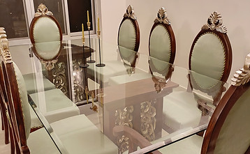 Elegant glass-top dining table with eight chairs