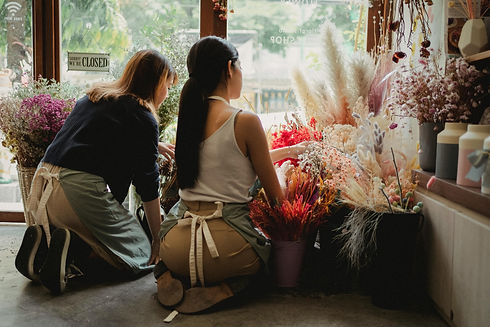 Florists sitting on floor near bouquets
