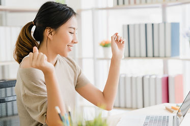 beautiful-young-smiling-asian-woman-working-laptop-desk-living-room-home.jpg