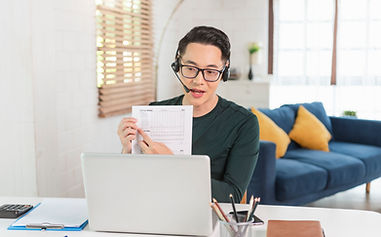 smiling-handsome-asian-businessman-wear-headphones-working-remotely-from-home-he-is-webina