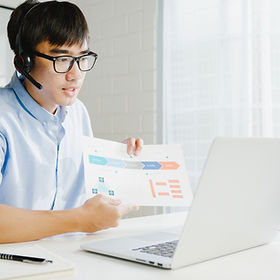 young-asia-businessman-using-laptop-talk-colleagues-about-plan-video-call-while-smart-work