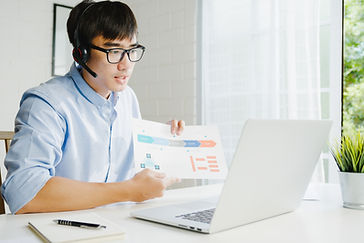 young-asia-businessman-using-laptop-talk-colleagues-about-plan-video-call-while-smart-work