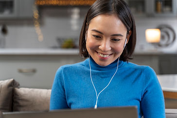 smiley-woman-with-laptop-home-medium-shot.jpg