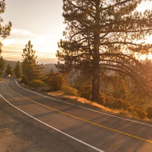Open road at sunset stretching toward the horizon