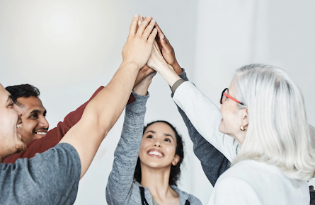 Support group sharing a high five, symbolising encouragement in getting sober without rehab.