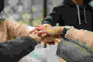outstretched arms, hands touching in the middle