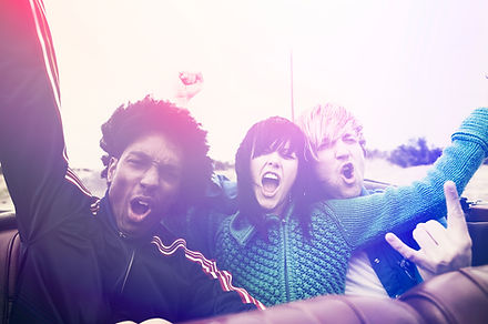 Excited group of friends in car