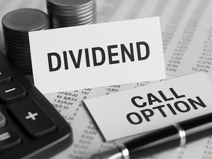 Calculator, pen, and coin stacks on financial documents. Cards read "DIVIDEND" and "CALL OPTION," conveying a business finance theme.
