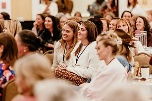 Belong-conference-young-women-listening-to-speakers