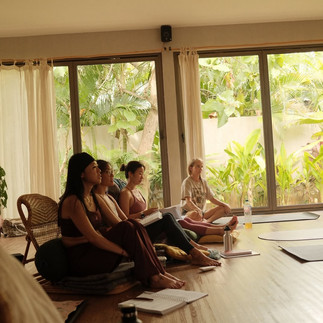 Group of people sitting on the floor in a wellness or mindfulness session