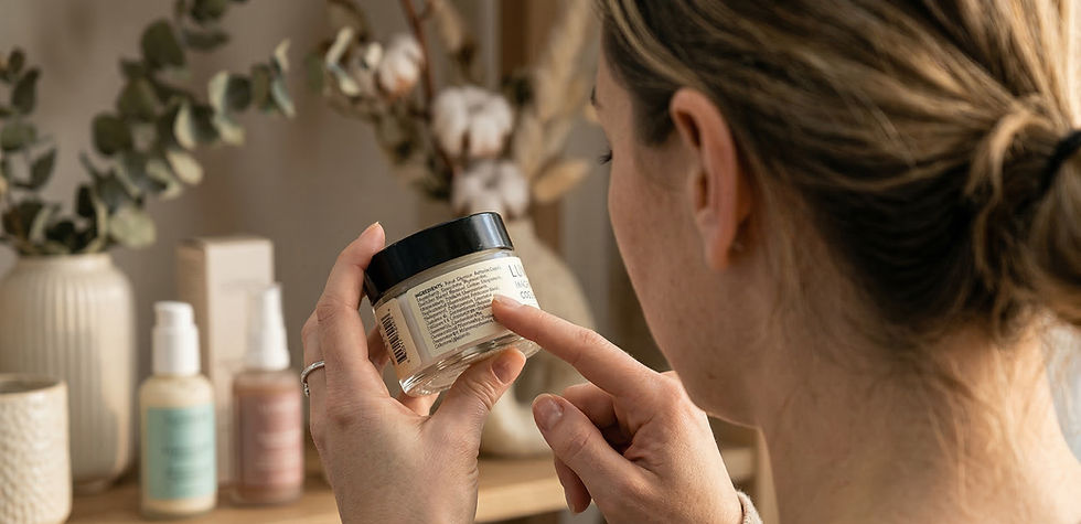 Person reading a jar's label in a cozy room with plants and cosmetics. Neutral colors and a focused atmosphere.