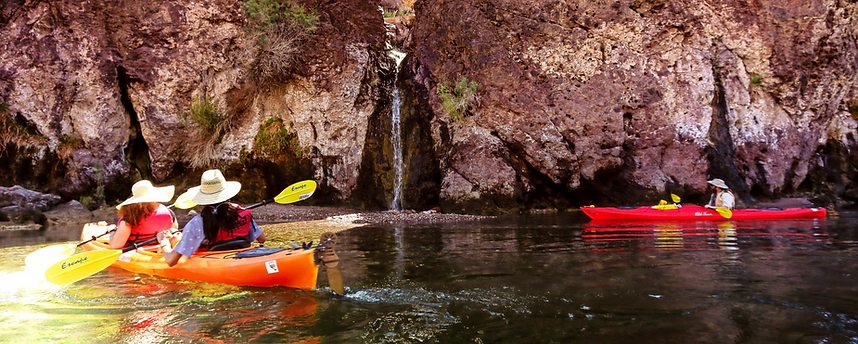 Kayakers glide past a waterfall near Lone Palm Canyon