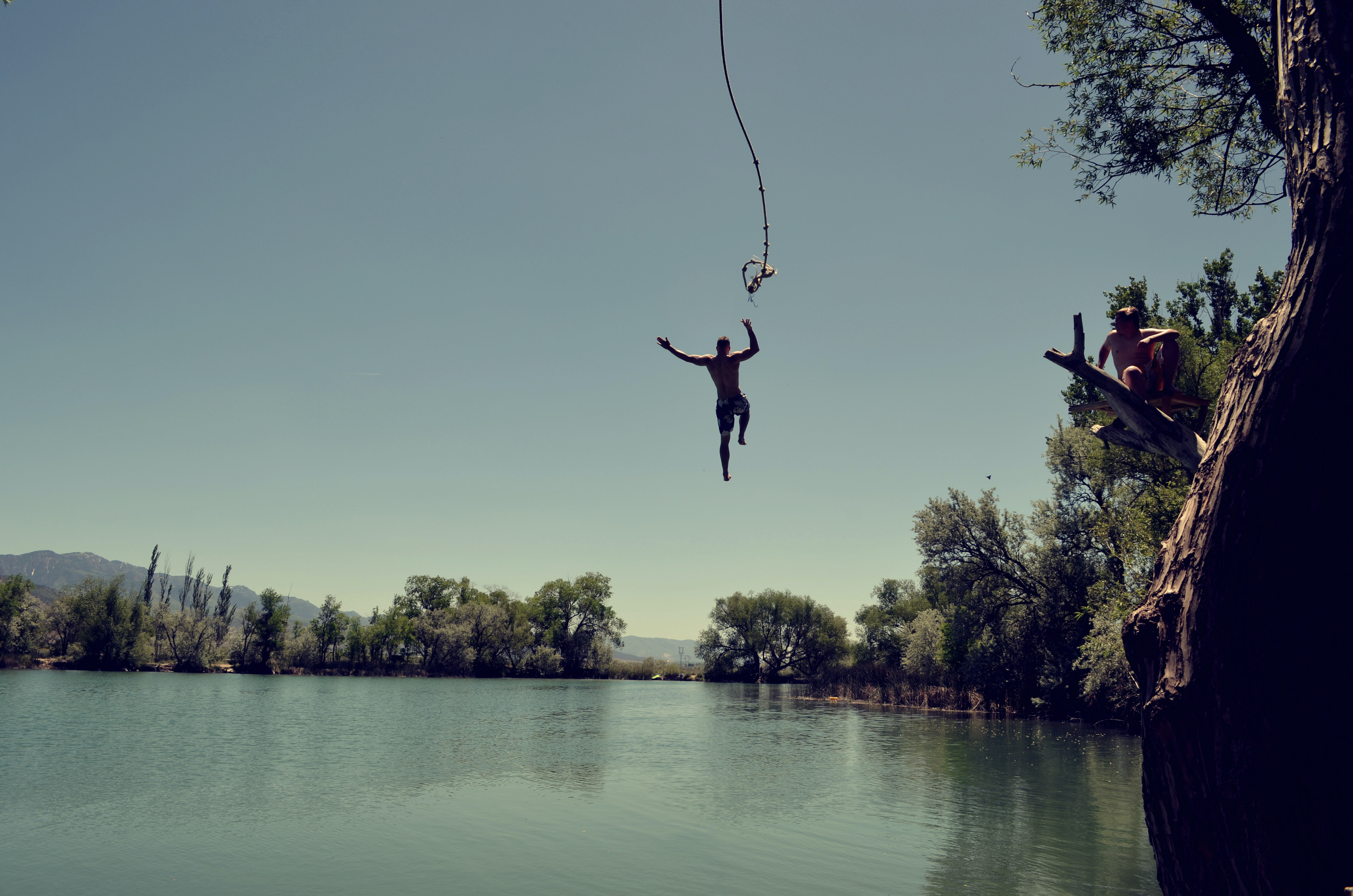 Boy jumping off a cliff representing how the YOLO mentality will help jumpstart travel post-Covid