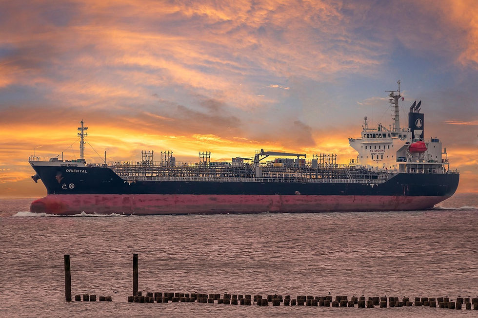 A cargo ship at sea during sunset
