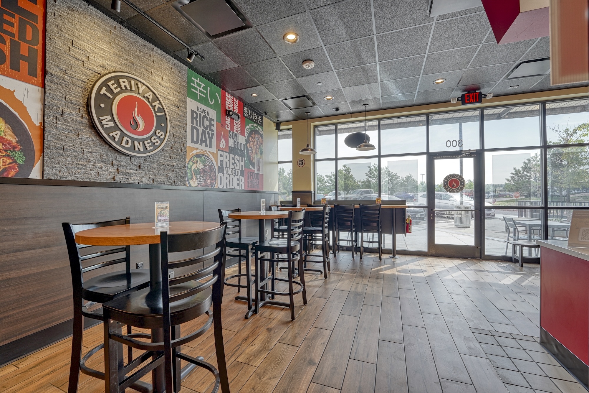 Teriyaki Madness Parker completed dining area with ceiling lighting and storefront windows