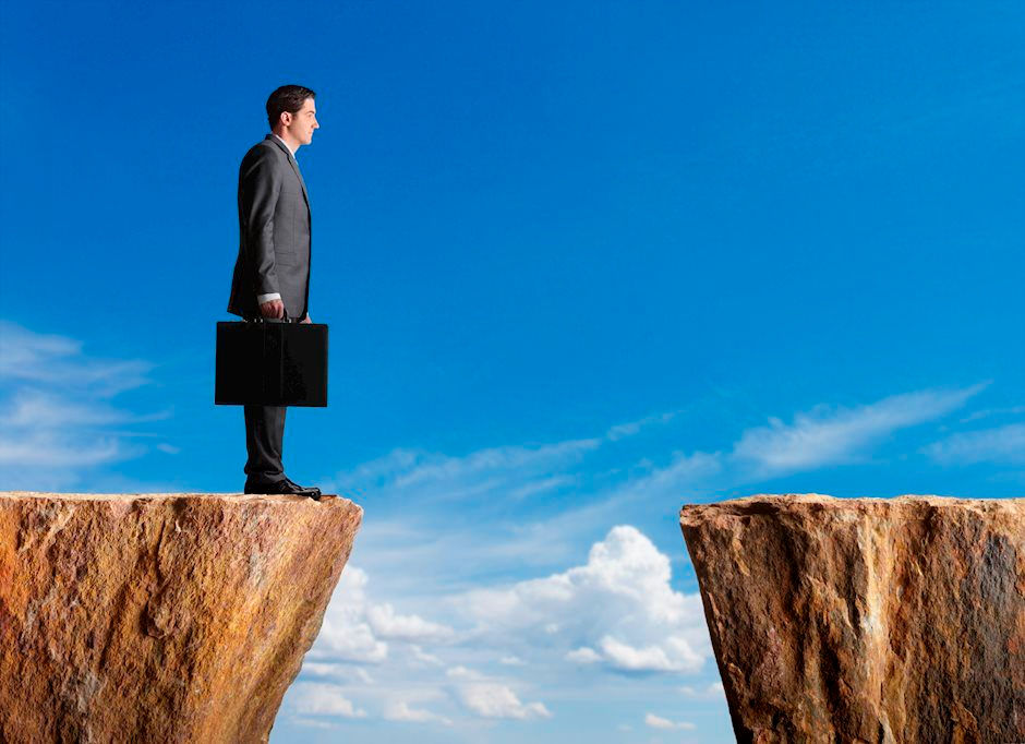 business-standing-at-edge-of-cliff-looking-towards-other-side-22666734_XtraLarge.jpg