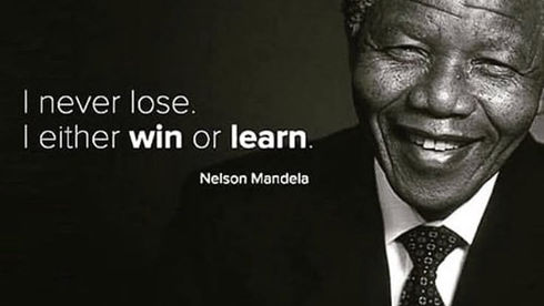 Image of a smiling man wearing a suit on a black-grey background. Text reads "I never lose. I either win or learn." Below, it has the name, Nelson Mandela.