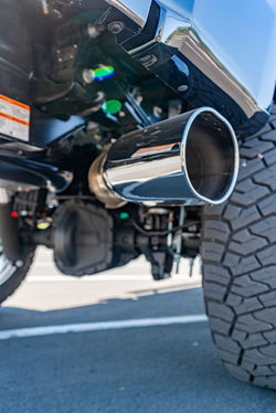 Aftermarket performance exhaust installed on a custom lifted 2026 Ford F-350 Super Duty