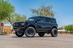 Lifted Ford Bronco three-quarter view with Method wheels, 35-inch Toyo tires, and custom p