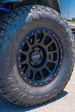 Front Method wheel with 35-inch Toyo tire and purple accent bolts on lifted Ford Bronco