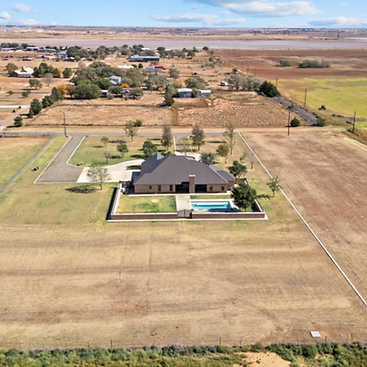 7901 N County Road 2140, a luxurious North Lubbock County estate featuring a 4-bedroom, 3.5-bath main house, a guest home, 2 workshops, and a pool, situated on 59 acres of land. Listed by Top Lubbock and West Texas Real Estate Agent, Lainie Eilenberger of Key and Slate Real Estate Group.