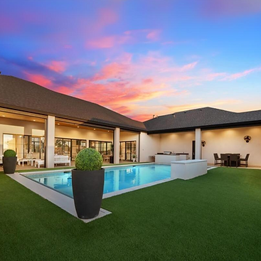 Luxury 5-bedroom, 7-bathroom home located at 14914 Miami Avenue in Lubbock, TX, listed for $2,100,000 by top Lubbock and West Texas Real Estate Agent, Lainie Eilenberger with Key & Slate Real Estate Group. This modern luxury home features 5,505 sq ft of living space, a saltwater pool with a waterfall, a dedicated office, a pre-wired basement, and a chef’s kitchen with top-tier appliances and a butler's pantry. Situated in the exclusive gated community, The Oaks at Sedona, this energy-efficient smart home offers a private oasis with a tanning deck and spacious outdoor living.