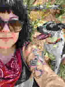 dog wears handmade collar and hipster girl