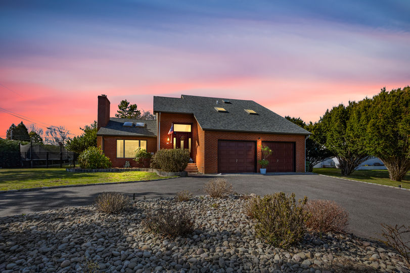 Exterior front view of home with virtual sunset edit creating warm twilight ambiance – property photo Rhode Island