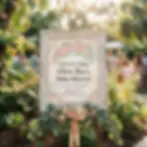 Digital illustration of a floral welcome sign for a baby shower. Displayed outdoors, it creates a warm and celebratory atmosphere.