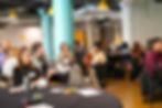 Summit attendees watch presenters on the theme of Emergent Strategies.