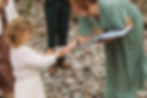 Kim Petrie Celebrant accepts rings from flower girl.