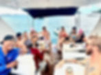 Group celebration on a yacht deck.