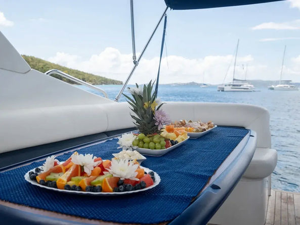 Dining setup on a yacht deck with ocean views.