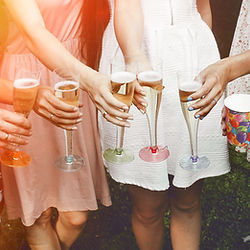 Friends toasting with champagne at a private studio event.