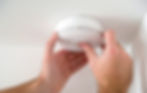 Man installing smoke or carbon monoxide detector.jpg
