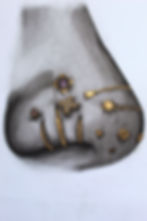 Charcoal drawing of the right side of a heavily-pierced nose with gold and soft pastel gem accents.