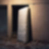 an abandoned mattress leaning upright against a wall, at night.jpg