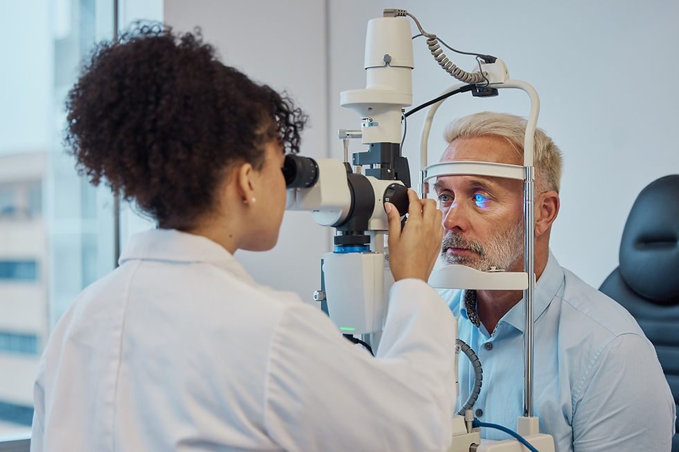 Eye doctor examines an older man with a slit lamp in a bright clinic; he looks serious and focused.