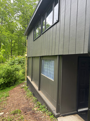 Side view of home after exterior repaint and before decorative wood trim installation.