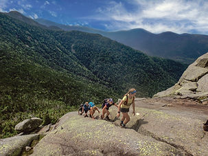 teens hiking up a mountain