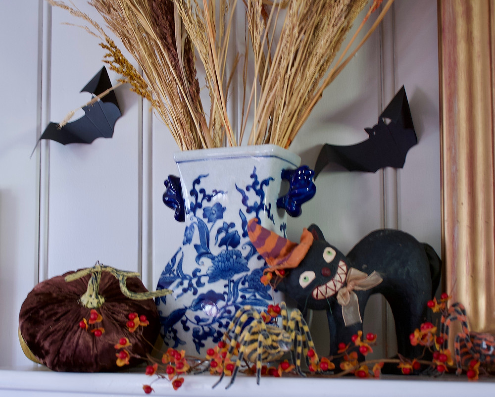 I enjoy decorating with older, gathered pieces that have a memory or some sort of meaning attached. I love this black cat. It was the first Halloween decoration I bought when I was a newlywed 27 years ago. The cat's face reminds me of my husband's (Mr. O) face when he learned that we would be decorating for Halloween!