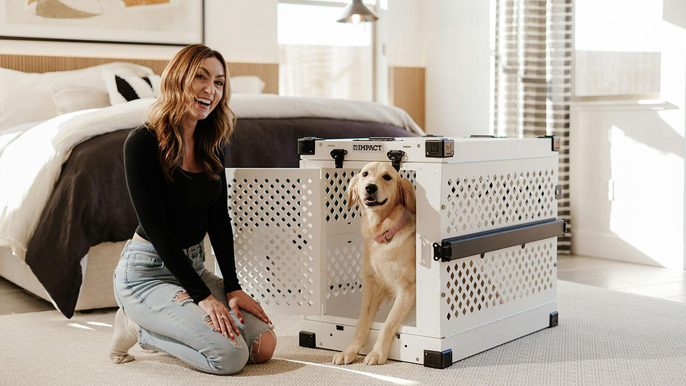 A cheerful woman poses with a golden retriever next to a premium dog crate in a stylish bedroom.