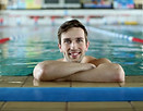 Young male swimmer displaying achievement and pride, representing improved performance times through Fairhope Heat's supportive community.