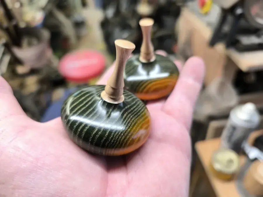Handmade wooden ring holders polished using a buffing tree system in the workshop