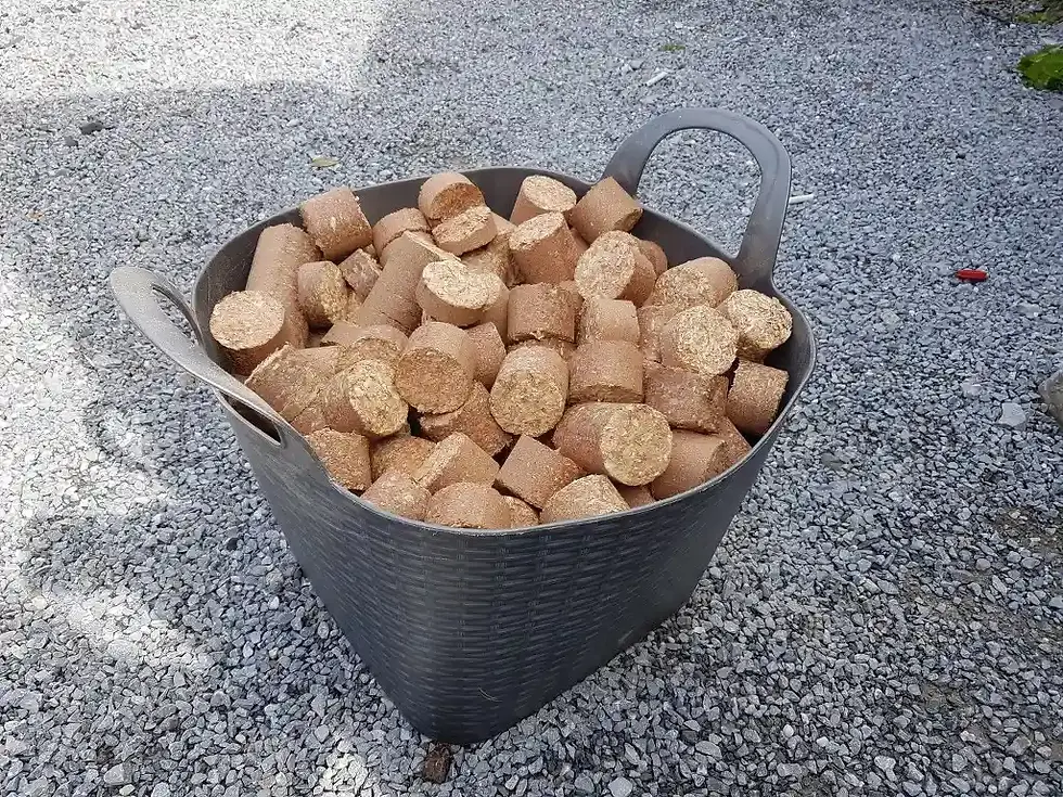 Wood briquettes made from recycled woodturning shavings in a workshop setting