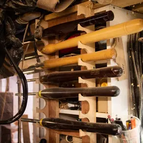 woodturning tools on a rack, some used every day, others seldom used
