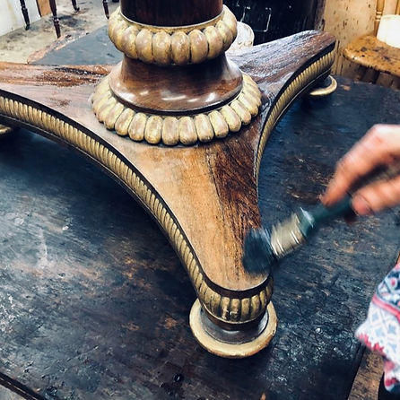 Specialist craftsmen upcycling an antique table