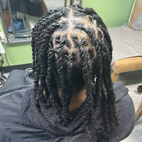 Client with professionally styled two-strand twists on natural hair at Junons World.