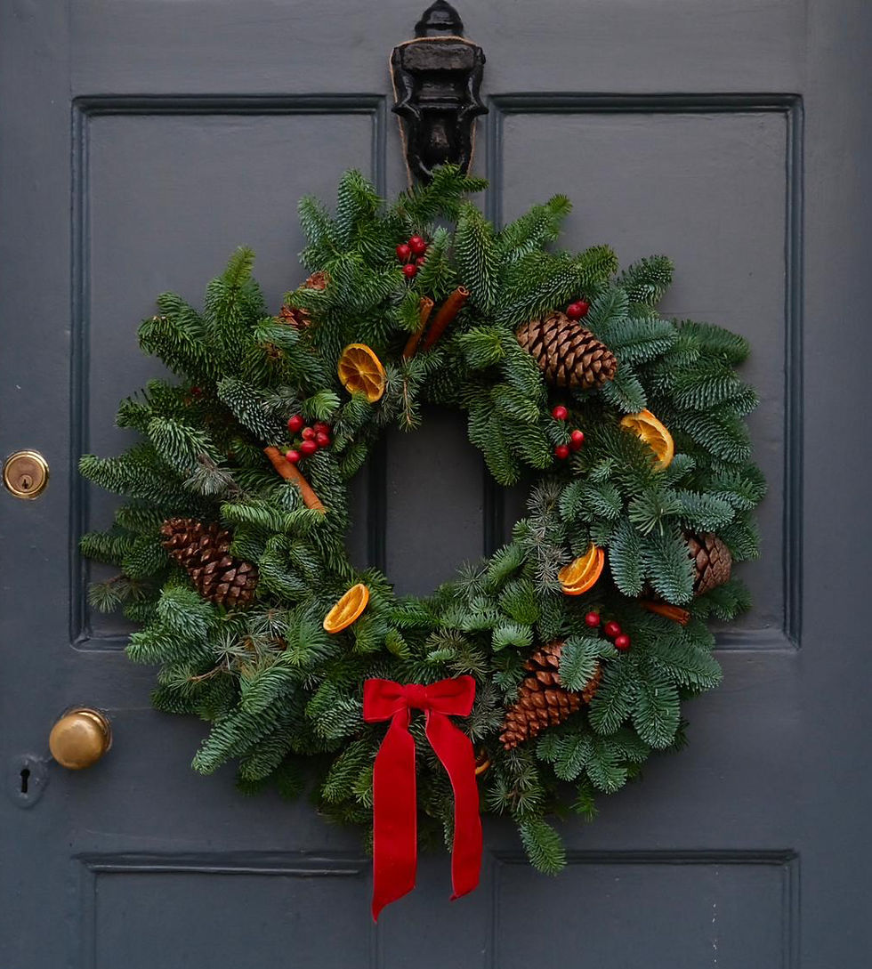 Traditional Christmas wreath with dried oranges, pinecones, and red berries.