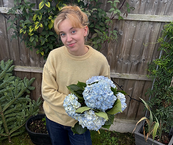 Lou, Cambridge-based florist, arranging seasonal flowers at Fleur de Lou